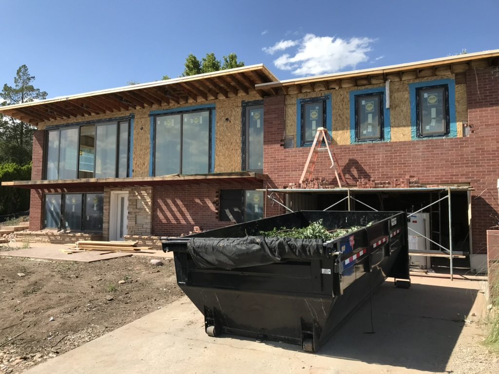 Whole-home remodel with new windows installed and exterior sheathing in place