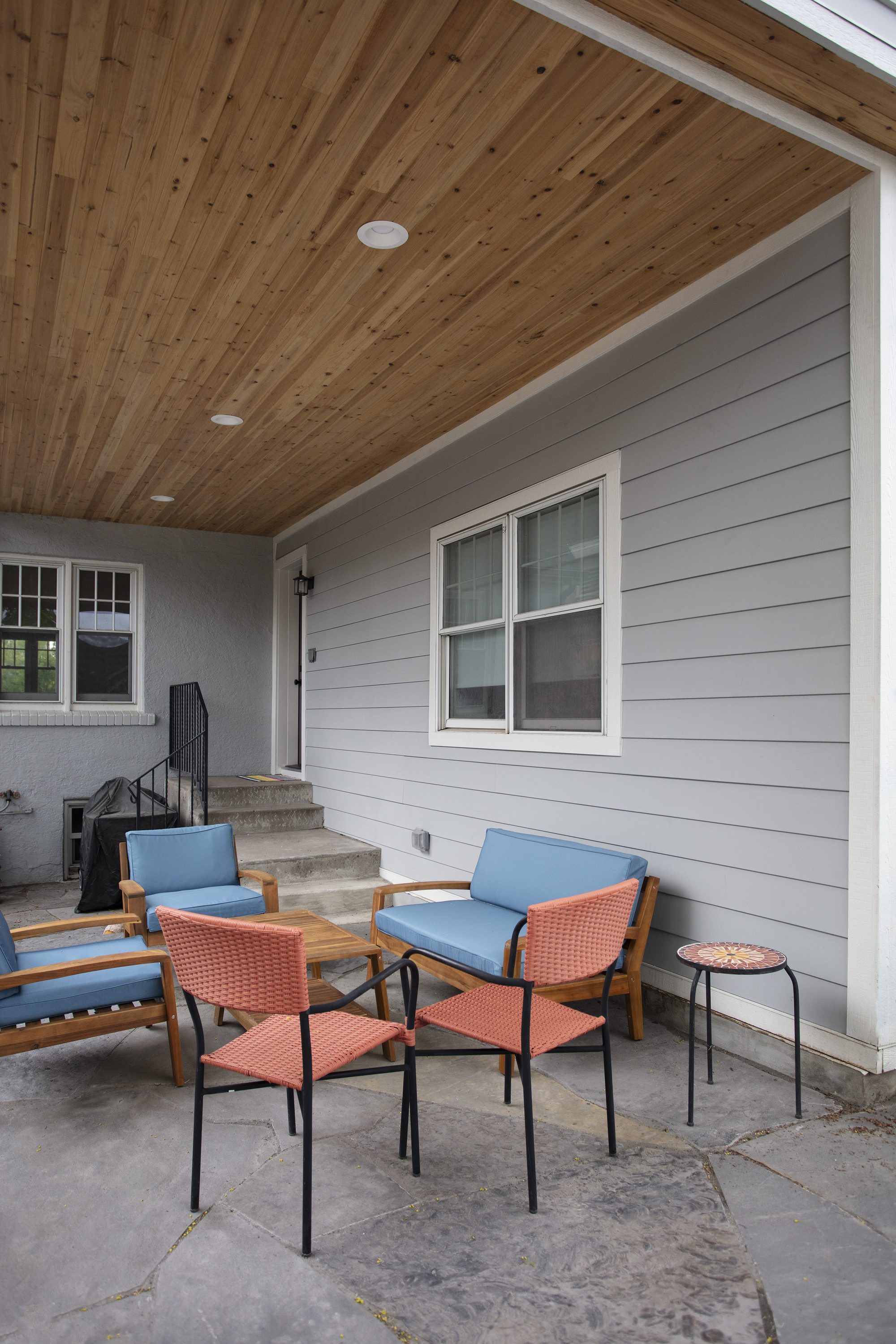 Covered patio addition with a tongue-and-groove wood ceiling