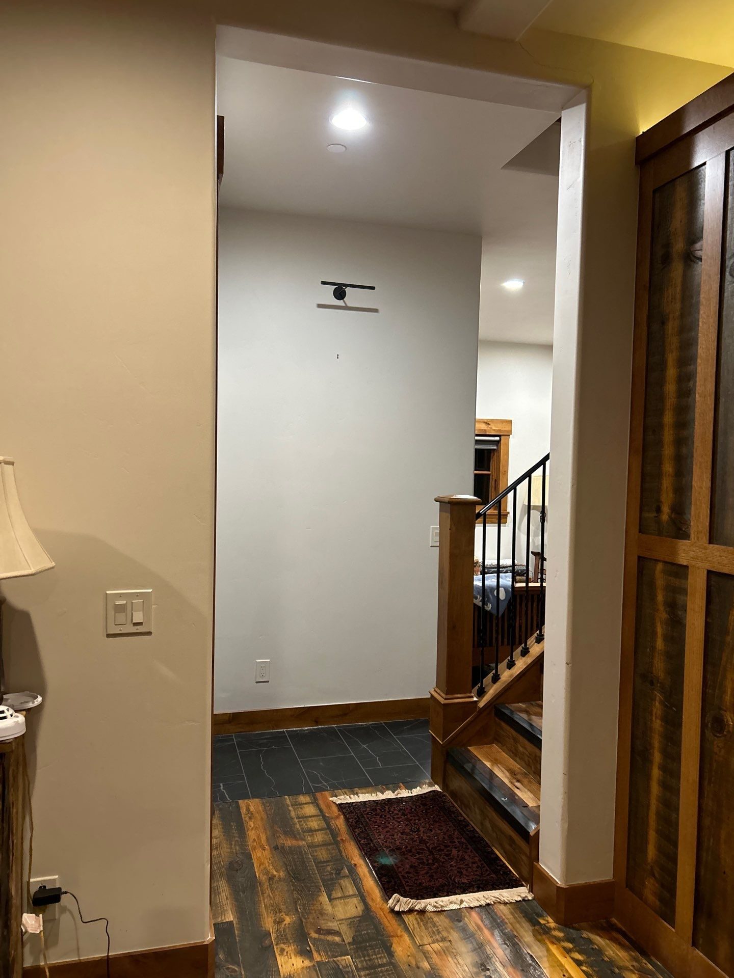 Entry in Park City, Utah with reclaimed wood flooring, slate tile and a rustic timber stair