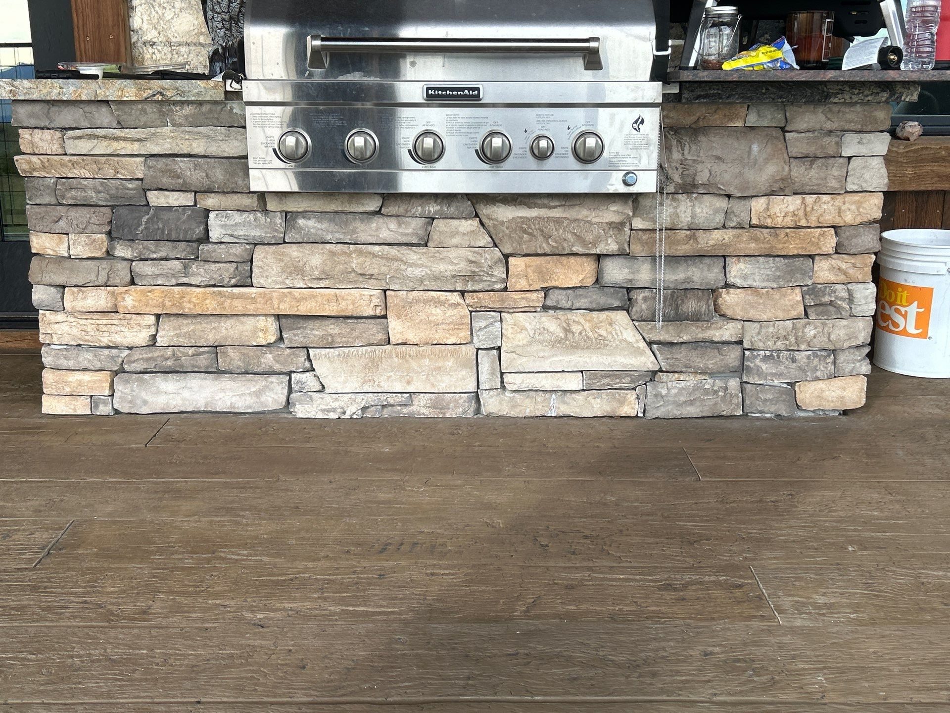 Outdoor kitchen in Park City, Utah with a stacked stone grill surround and granite counter